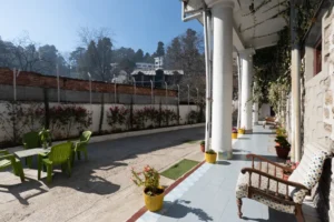 Outdoor seating area at Royal Heritage Nainital with garden and mountain views
