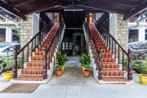 Grand staircase with wooden railings inside Royal Heritage Nainital hotel